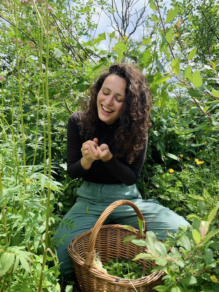 Photo of happy woman with basket in a garden.